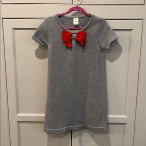 Grey sweater dress with orange bow.